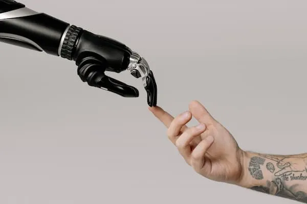 Human and robot hands meeting, representing human-machine interaction